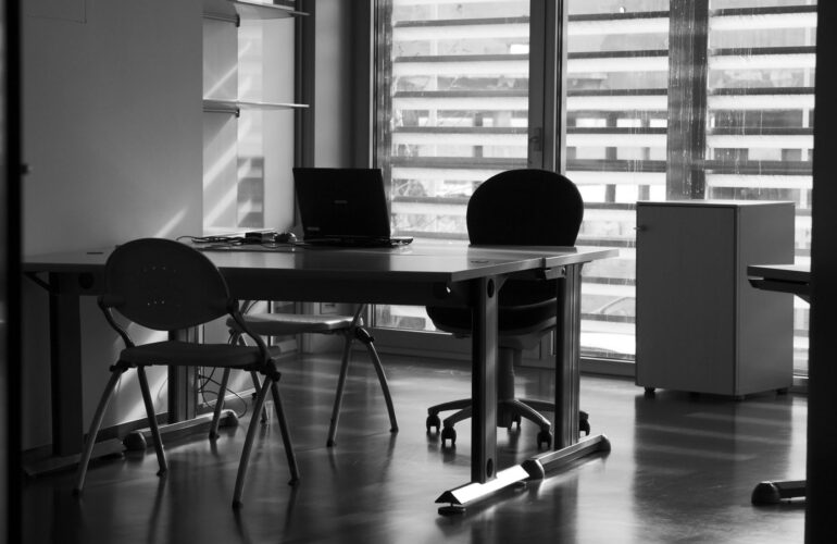 photo of empty desk representing time lost to meaningless meetings